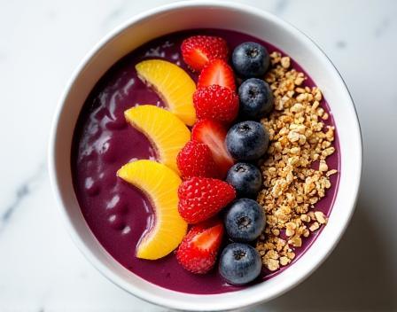 Artistically arranged acai bowl with fresh fruit.